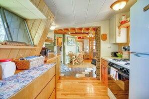 Enjoy family meals at the dining table in this fully equipped kitchen with oven and refrigerator.