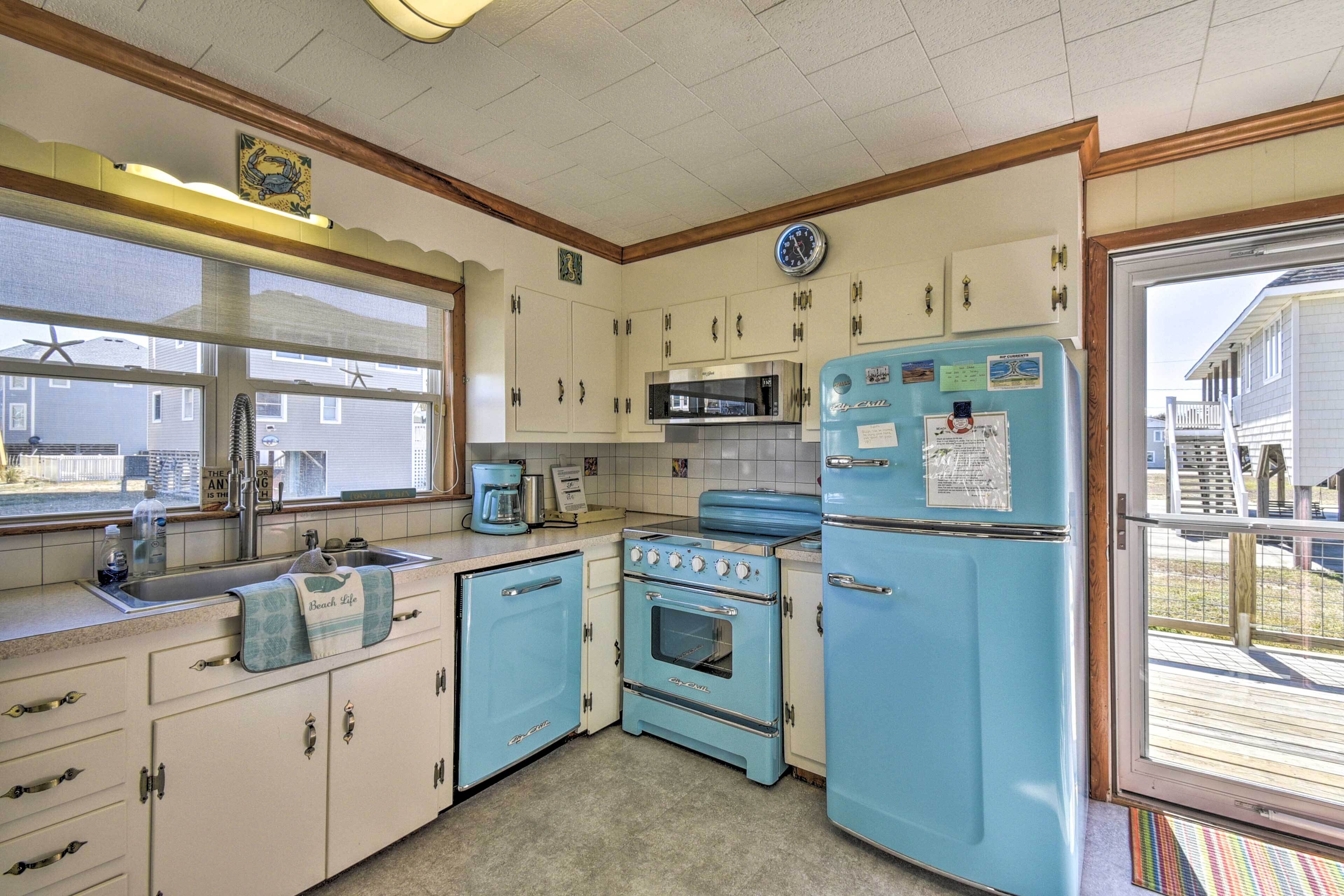 A vintage kitchen with a sink, stove, and refrigerator.