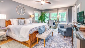 A bedroom with a bed, a desk, a chair, a television, and a ceiling fan. - Cozy Hideaway w/ Grill, 17 Mi to Asheville (Black Mountain)