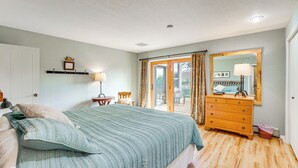 A bedroom with a bed, dresser, and a window with curtains. - 'mesa View House' w/ Hot Tub: Walk to Winery! (Palisade)