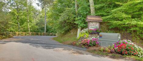 A road leading to a gated entrance with a sign for Briarcliffe Condominium.