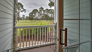 A porch with a view of a grassy area and trees. - Golfer's Paradise: Myrtle Beach Condo w/ Pool! (Myrtle Beach)