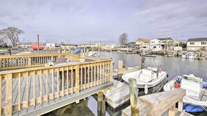 A wooden dock extending into a marina with several boats docked. - Island Park Couple's Escape ~ 1 Mi to Beach! (Island Park)