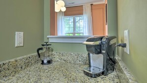 A kitchen with a coffee maker, a blender, and a window with curtains. - Modern Durham Retreat w/ Private Yard & Patio (Durham)