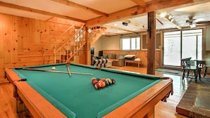 A pool table in a wooden-floored room with a staircase and a seating area in the background. - Cozy Bartlett Townhome < 3 Mi to Attitash Mountain (Bartlett)