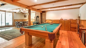 A pool table in a room with wooden floors and a brick wall. - Cozy Bartlett Townhome < 3 Mi to Attitash Mountain (Bartlett)