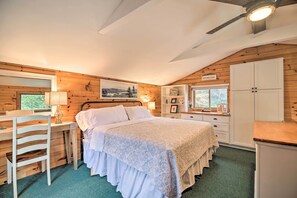A cozy bedroom with a bed, a desk, and a wardrobe. - 'skylight' Adirondack Cabin w/ On-site Lake (Saranac Lake)