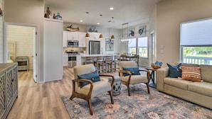 A spacious living area with a sofa, two armchairs, a coffee table, and a dining area with a table and chairs. - 6 Mi to Beach: Rockport Home w/ Pool Access! (Rockport)