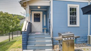 A blue house with a front door, a small porch, and a grill outside. - Pet-friendly Murph Landing - 1 Mile to Wvu! (Morgantown)