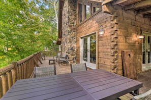 Enjoy dining or socializing on the deck with a view of the lush landscape.