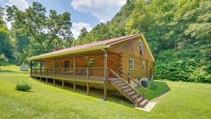 A log cabin with a porch, a staircase, and a covered deck. - Serene Mountain Retreat on 40 Acres w/ Fire Pit! (Bomont)
