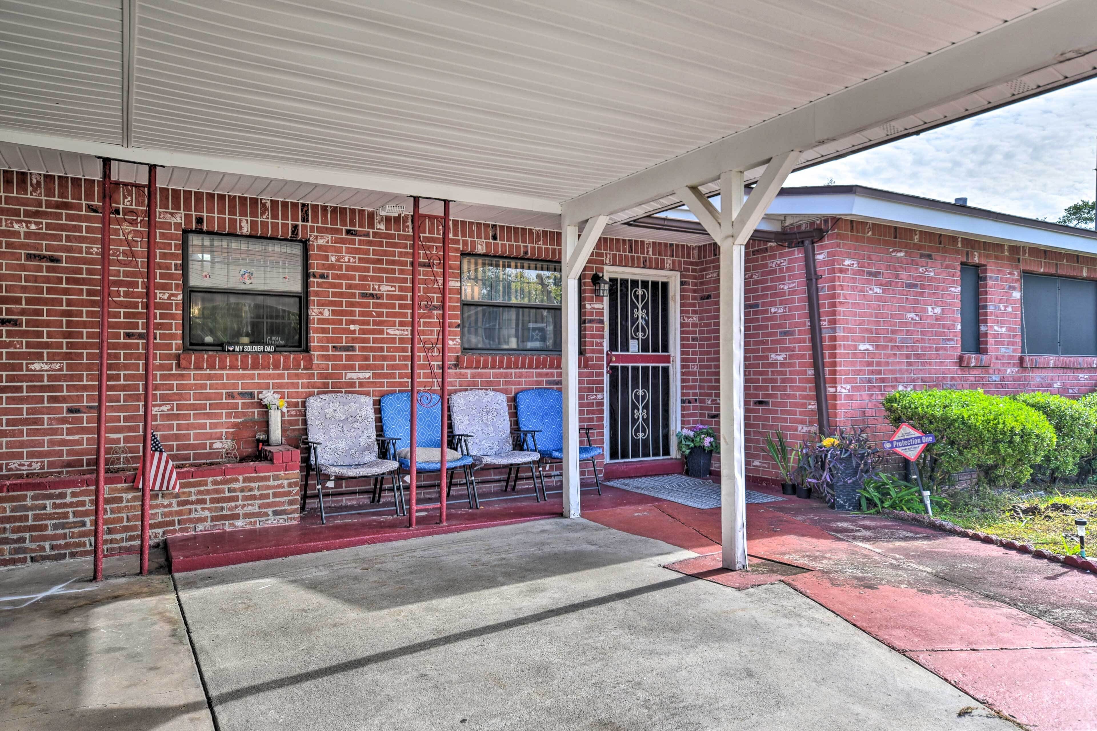 A covered outdoor seating area with brick walls, a metal gate, and a "Protection Zone" sign.