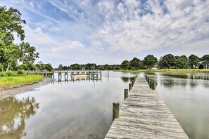 A wooden dock extending into a calm body of water, surrounded by lush greenery and trees. - Pet-friendly Woodsy Gem: 1/4 Mi to Chesapeake Bay (Painter)