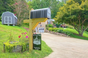 A mailbox on a wooden post with a welcome sign below it. - Fire Pit & Game Room: Family Home in Marshall! (Weaverville)