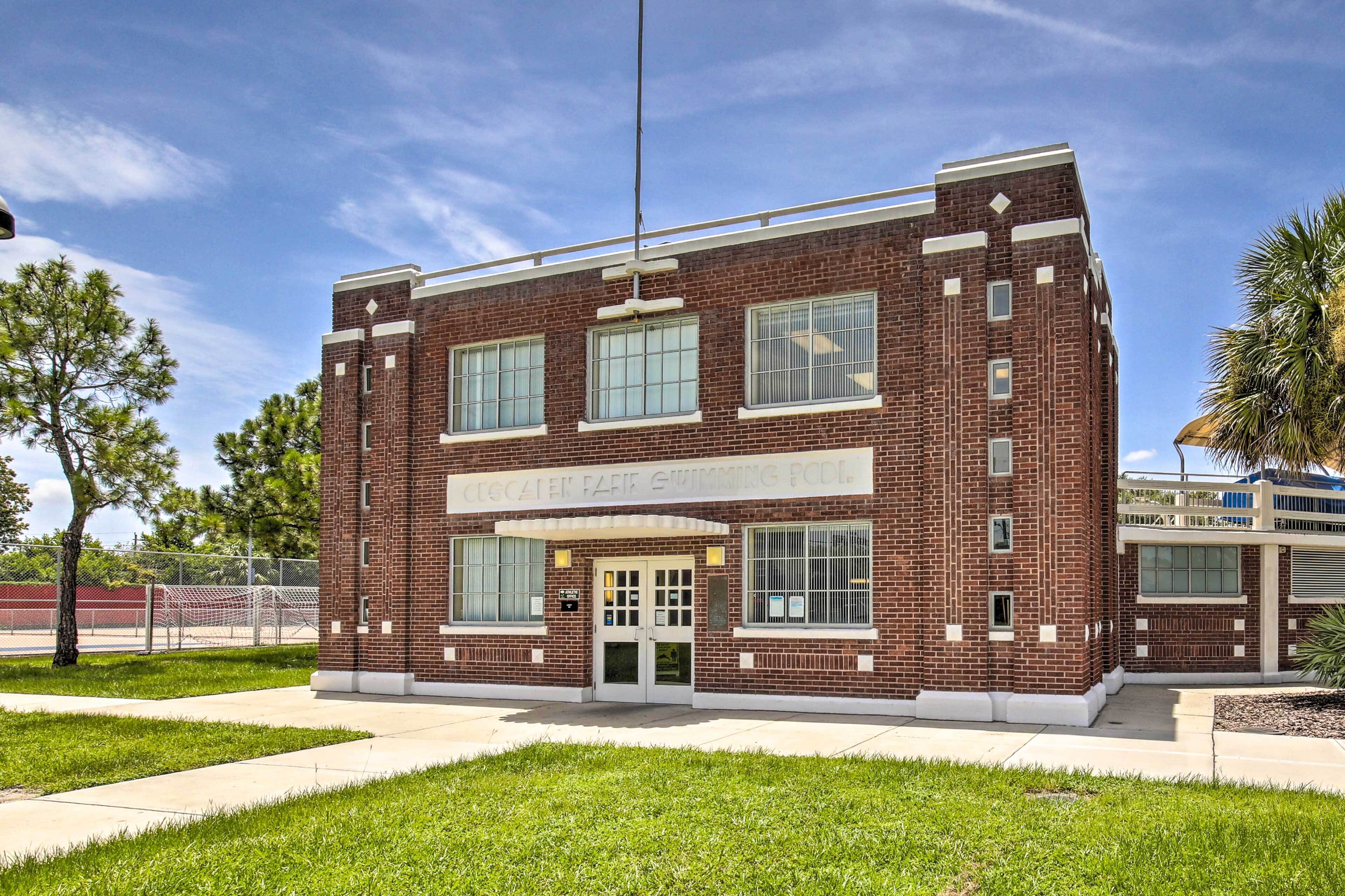 A brick building with a sign reading "Cocoa Beach Swimming Pool".