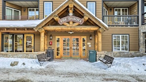 A building with a sign reading "The Dakota" and a wooden entrance with glass doors. - Keystone Ski Condo w/ Mtn View - Walk to Gondola! (Keystone)