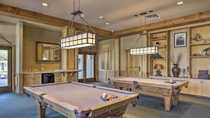 A pool table with a billiard cue and balls, a wooden bar area, and a mirror on the wall. - Keystone Ski Condo w/ Mtn View - Walk to Gondola! (Keystone)