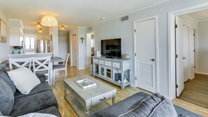 A modern living room with a sofa, coffee table, and entertainment unit.