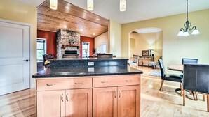 A kitchen with wooden cabinets, a granite countertop, and pendant lighting. - King Suite Haven Near Dale Hollow Lake & Boat Slip (Burkesville)