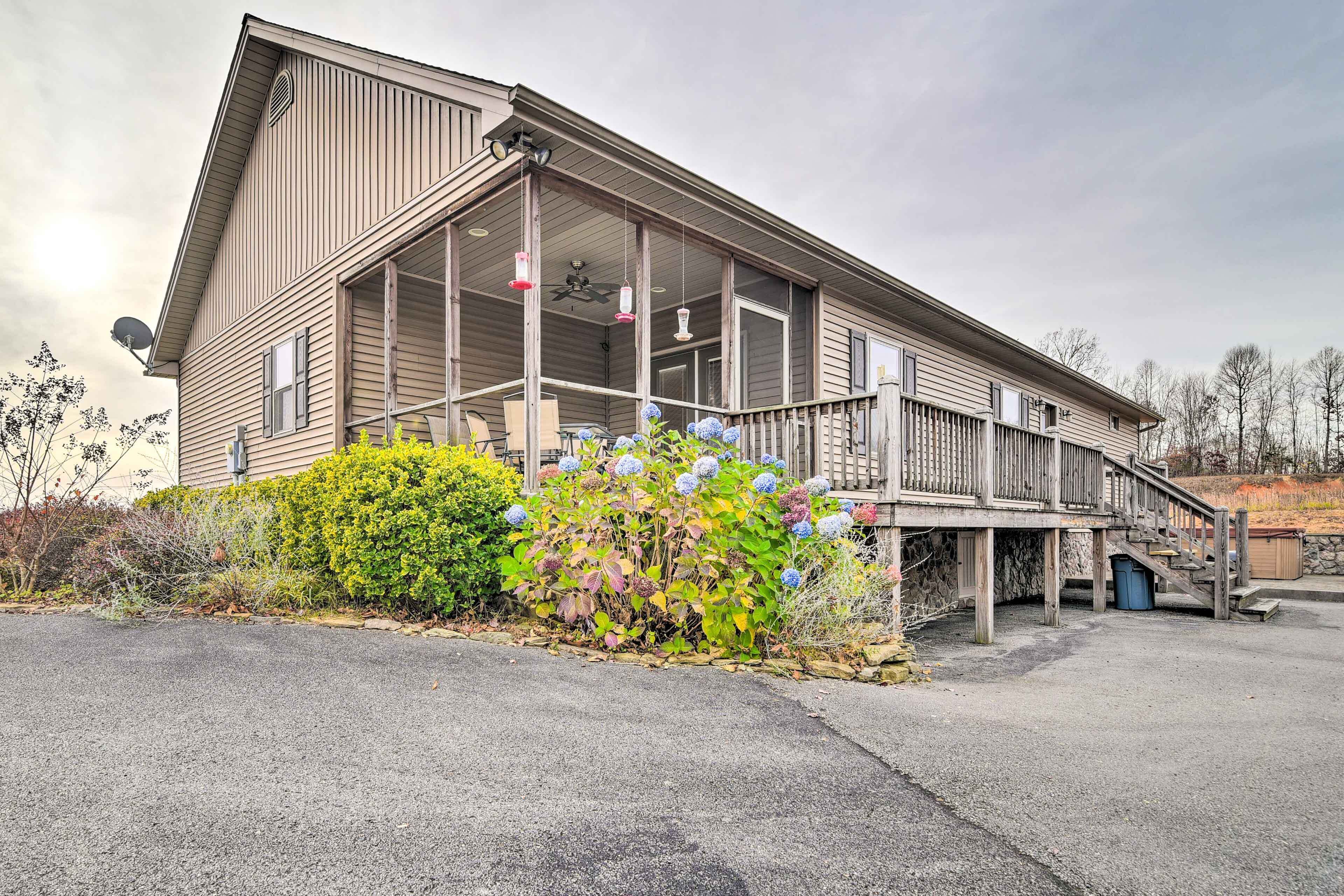 A two-story building with a covered porch and a staircase leading to the upper level.