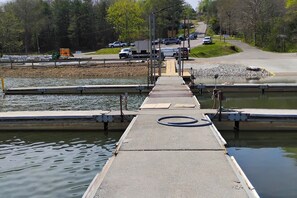 A concrete dock leading into a body of water with a circular marking on the dock's edge. - Hilltop Hideaway, 5 Private Acres + Boat Slip (Burkesville)