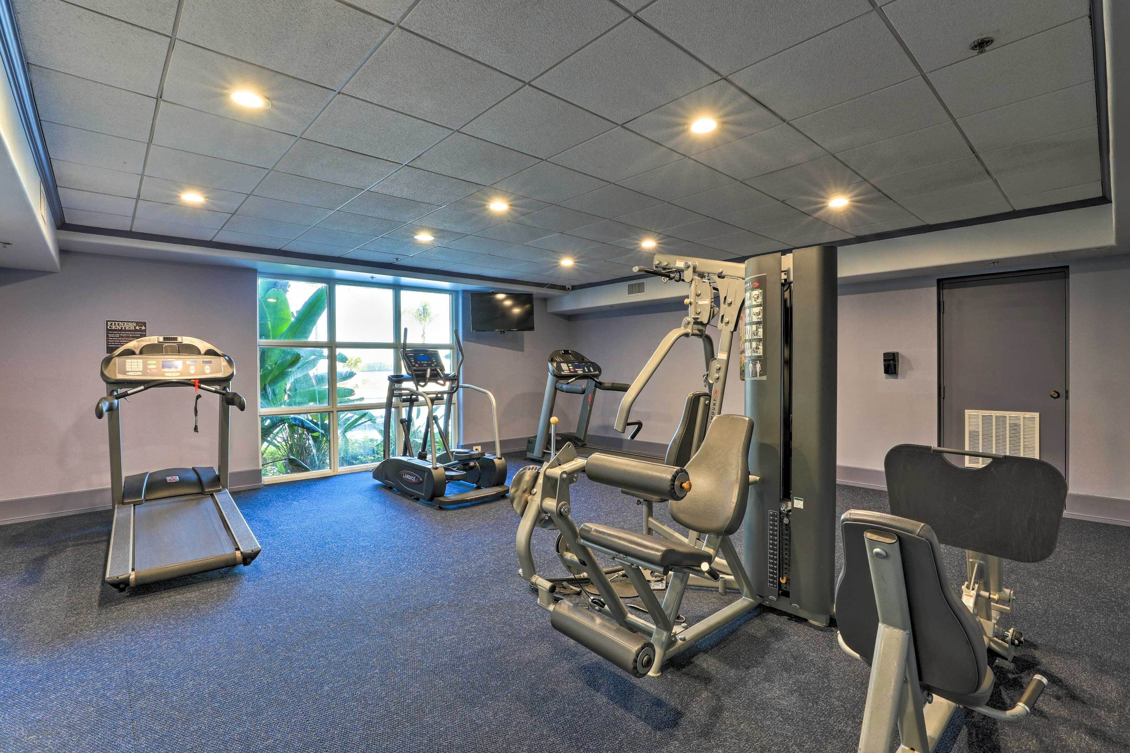 A gym with treadmills, weight machines, and a stationary bike.