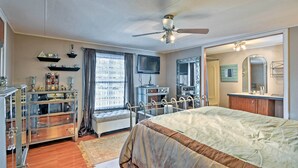 A bedroom with a bed, a ceiling fan, a television, a dresser, and a window with curtains. - Hot Tub & Deck: Tranquil Home Near Grand Lake (Grove)