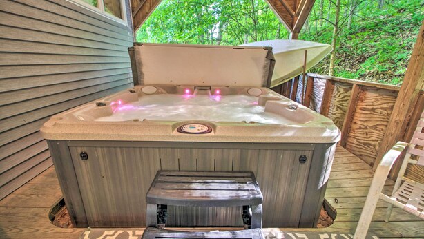 A hot tub with a control panel, a step for access, and a wooden deck with a railing. - Ludlow Home w/ Hot Tub, Near Okemo Resort! (Ludlow)
