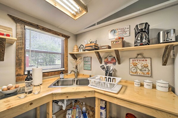 A kitchen with a wooden countertop, a sink, and shelves with kitchen items. - Bring a Pet: Smoky Mtn Vacation Rental w/ Yard! (Whittier)