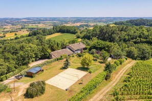 Escape to a serene rural retreat surrounded by lush greenery and expansive fields.