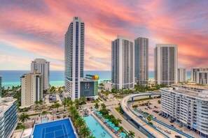 A high-rise hotel with a pool area, multiple floors, and a view of the ocean. - Oceanfront Oasis: Luxury, Sunrise Views, Resort (Hollywood)