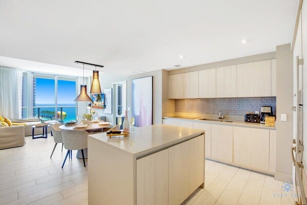 A modern apartment with a kitchen, dining area, and living room. - Oceanfront Oasis: Luxury, Sunrise Views, Resort (Hollywood)