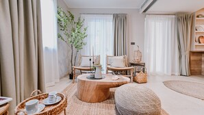 Una sala de estar acogedora con muebles de mimbre, una mesa de centro de madera y una planta en maceta.