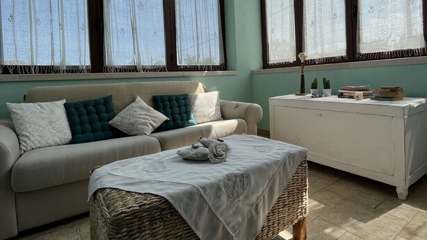 A living room with a sofa, a coffee table, and a cabinet.