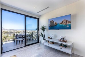 Enjoy a spacious living area with a sliding glass door leading to an outdoor space and scenic views.