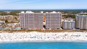 A beachfront hotel with multiple high-rise buildings, a sandy beach, and a clear view of the ocean. - Stunning Oceanfront Condo! Sleeps 8, Modern Appliances, Majestic (Panama City Beach)