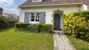A two-story house with a tiled roof, a front door with an arch, and a sign that reads "LE COTTAGE". - Le Cottage, Jolie Villa à 3 Minutes de la mer ! (Ambleteuse)