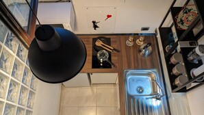 A compact kitchen with a built-in stove, a sink, and a small countertop. - Napoli City Panorama (Naples)