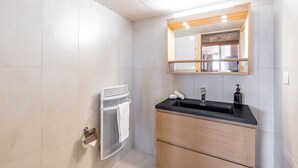 A modern bathroom with a black sink, wooden vanity, and a mirror above the sink. - Chalet Gentil | Family friendly | Mountain getaway (Riddes)