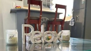 A glass-top table with two small containers labeled 'zen' and 'relax' on a kitchen counter. - Bucket List Stays (Ocho Rios)
