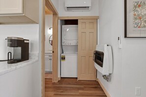A compact kitchen with a coffee maker, a washing machine, and a heater. - Onyx - Near Hocking Hills (Rockbridge)