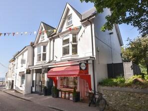 A traditional building with a red awning and a sign that reads "Butchers." - Fore Street House - Apartment 2 (Seaton)