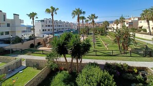 A residential area with modern buildings, palm trees, and a well-maintained garden. - 154 Casa Lelik (Tarifa)