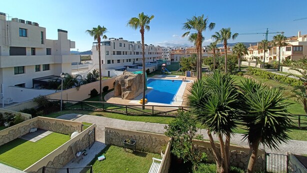A resort with a swimming pool surrounded by palm trees and modern buildings. - 154 Casa Lelik (Tarifa)
