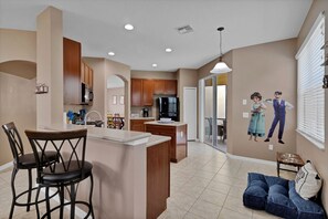Enjoy meals in the kitchen with a central island, dining table, and appliances.