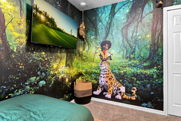 Experience the vibrant forest in our rooms, featuring a colorful mural and a comfortable green bed.