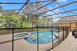 Relax by the pool surrounded by lush trees and enjoy a refreshing swim or soak in the hot tub.