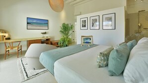 Une chambre moderne avec un grand lit, un bureau et une douche.
