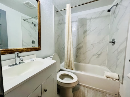 Shower, rainfall showerhead, towels, soap. The Express Inn