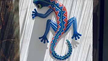A decorative lizard sculpture on a textured wall.